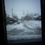 A snowy scene through the window.